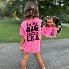 "Introducing our Girls Comfort Colors® T-Shirt, a stylish and personalized piece that celebrates the special role of being a big sister. With its unique design and customizability, this shirt is perfect for your little one to showcase her pride and individuality. The back of the shirt features a large and eye-catching print that boldly states \"In My Big Sister Era.\"  On the front, you'll find a trendy skeleton peace sign pocket print that adds a cool and fashionable element to the shirt. As an Big Sis Announcement, Big Little Sorority Shirts, Big Little Shirts, Funny Kids Shirts, Sister Shirt, Matching Mom, Big Sister Shirt, Big Sis, Shirts For Teens