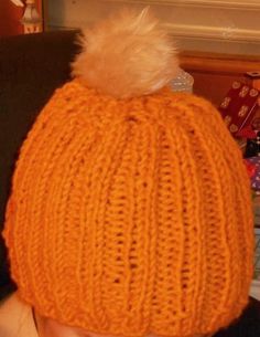 a child wearing an orange knitted hat