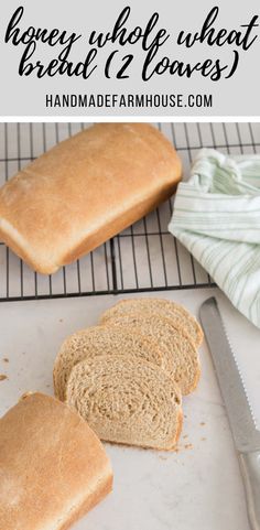 sliced loaf of bread sitting on top of a white cutting board next to a knife