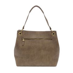 Reach for the brass ring with this generously sized tote fashioned in antiqued vegan leather. Featuring oversized gleaming rings and eyelets at the shoulder straps this casual yet polished style will become your new go to bag. 11.75 in. H x 13 in. W x 4.5 in. D Magnetic snap closure Non-adjustable short shoulder strap: 8 in. drop Removable and adjustable crossbody strap: 14 in. – 24 in. drop Brass plated hardware Tie zip pull 100% Vegan leather (polyurethane) Linen fabric lining One interior zip Polished Style, Brass Rings, Heeled Mules Sandals, Dark Taupe, Lunch Tote, Shoe Gifts, Brass Ring, Cuff Earrings, Leather Care