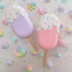 two ice cream pops with sprinkles on them