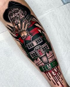 a man's leg with a tattoo on it and an image of a lighthouse