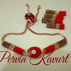 a red and gold beaded bracelet with an evil eye on the front, two other beads are attached to it