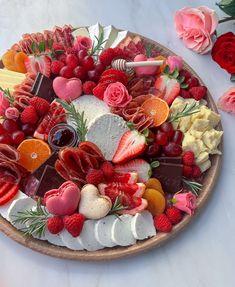 a platter filled with fruit and cheese