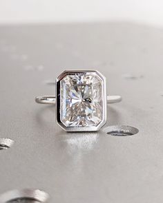 a diamond ring sitting on top of a table