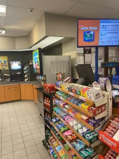 the inside of a convenience store with snacks and drinks on display in front of it