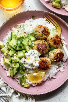 two plates with meatballs, rice and cucumbers on them next to a glass of orange juice