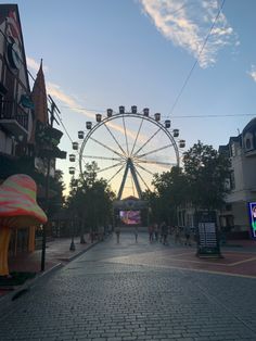 a ferris wheel is in the middle of an empty street