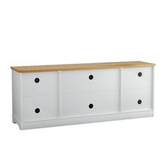 a white dresser with black dots on the drawers