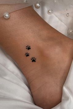 a woman's foot with two paw prints on it