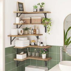 a bathroom with green tile and shelves filled with toiletries, plants and other items