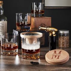 an assortment of whiskeys and glasses on a table