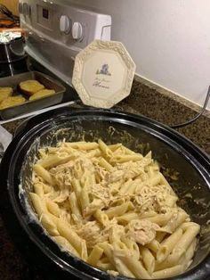 some food is in a black bowl on the kitchen counter next to an appliance