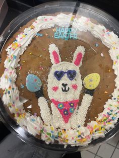 a cake decorated with an image of a llama wearing sunglasses and holding tennis rackets