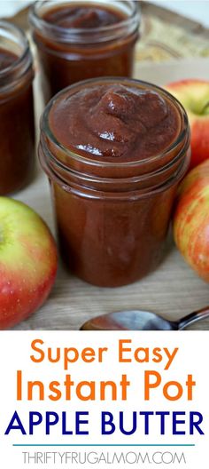 three jars filled with apple butter sitting on top of a wooden table next to apples