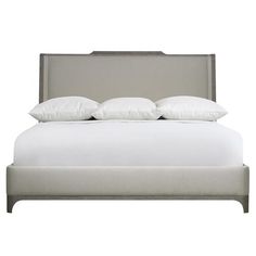 a bed with white sheets and pillows on it's headboard, against a white background