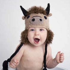 a baby wearing a knitted animal hat