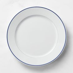 an empty white plate with blue trim on it