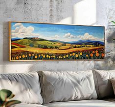 a painting hanging on the wall above a couch