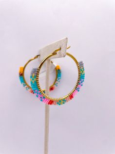 Transform your summer style with our Bold Beaded Hoop earrings! These multicolor hoops are the perfect addition to your beach look. Made with stainless steel, they are durable and lightweight. Measuring at 1.5 inches, they add a touch of fun and elegance to any outfit. Elevate your jewelry game now! Beaded Wrapped Hoop Earrings, Lavender Brown, Beaded Hoop Earrings, Beaded Hoops, Mini Cocktail Dress, Digital Gifts, Beach Look, Dressy Casual, Hat Hairstyles