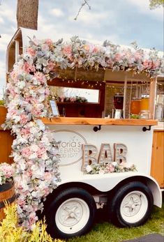 a food truck decorated with flowers and vines