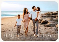 a family walking on the beach holding hands and looking at each other with happy holidays written below