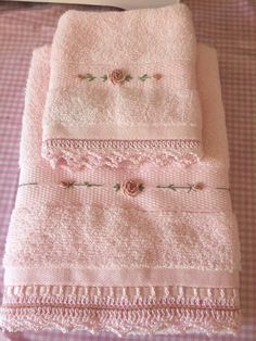 pink towels are stacked on top of each other