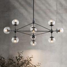 a chandelier with glass balls hanging from it's center and four lights on each side