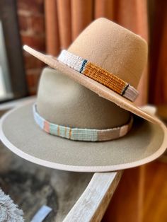 One of a kind hand woven hatbands in beautiful boho colors and patterns.  Hand woven by me on a wooden loom using luxurious fibers like linen, cotton, raw silk, bamboo and hand spun yarn. Perfect for that Fedora or summer straw hat . Price is per hat band. Standard fedora size (23 1/2 inches long) width is about 3/4 of an inch but can be woven to any size specifications. Always open to custom color & design ideas! You can shoot an email inquiring what is currently in stock, send me a screenshot Handwoven Natural Hat Band With Flat Brim, Artisan Handwoven Fedora, Artisan Woven Flat Brim Hats, Artisan Woven Hats With Short Brim, Brimmed Woven Fedora For Festival, Artisan Handwoven Wide Brim Fedora, Artisan Handwoven Fedora Hat, Cream Bohemian Brimmed Straw Hat, Artisan Handwoven Adjustable Fedora