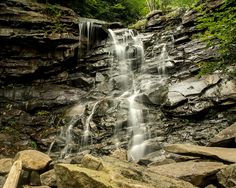 there is a waterfall in the middle of some rocks