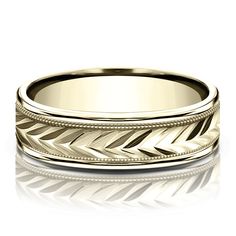 a wedding band with an intricate design in yellow gold