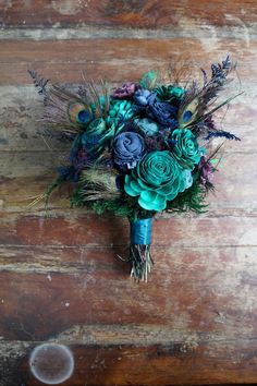 a bouquet of flowers sitting on top of a wooden table