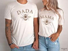 a man and woman standing next to each other wearing shirts that say dada and mama