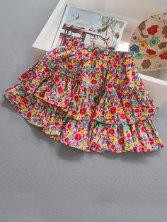 Time for some flower fun in the summer sun! With a tiered floral skirt in her wardrobe, her adventures will be extra cute and charming. Just the right amount of sunshiney vibes to brighten up her season. Soft, lightweight fabric flows with her movements. Easy-breezy, beautiful finish! Elastic waist allows wiggle room, so she won't feel restricted during adventures. Perfect for cowgirl fashion, summer adventures, casual outings, photoshoots, and more Tiered floral skirt with elastic waist Available in sizes 2T-7Y for toddlers and little girls Multicolor Fun Bottoms For Spring, Fun Multicolor Bottoms For Spring, Playful Floral Print Bottoms For Spring, Playful Floral Print Spring Bottoms, Spring Playful Ruffled Bottoms, Playful Ruffled Bottoms For Spring, Ruffled Bottoms For Summer Playtime, Playful Cotton Skirt For Spring, Playful Multicolor Bottoms For Spring