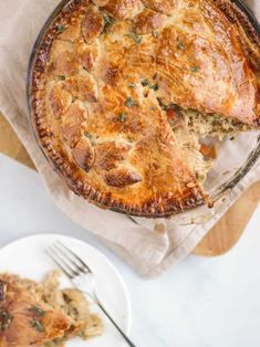 a close up of a pie on a plate with a fork next to the pie