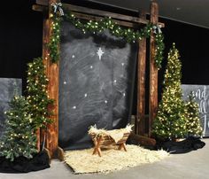 christmas decorations are displayed in front of a chalkboard backdrop and wooden sleigh