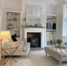 a living room filled with furniture and a fire place next to a book shelf full of books