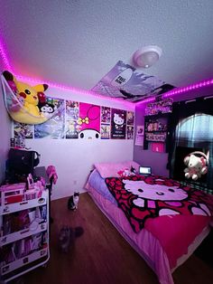 a bedroom decorated in pink and black with pictures on the wall