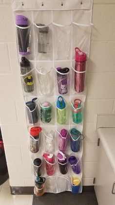 a wall mounted storage rack filled with cups