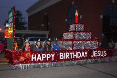 a group of people riding on the back of a float