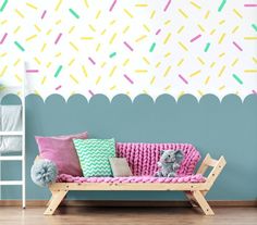 a child's room decorated in pastel colors and sprinkles on the wall