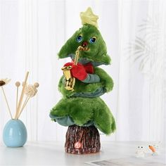 a green stuffed animal with a trumpet in its hand on top of a tree stump