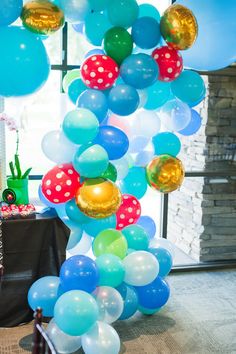 balloons and streamers are hanging from the ceiling