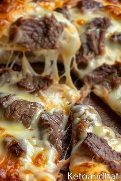 a close up of a pizza with cheese and meat on it's toppings