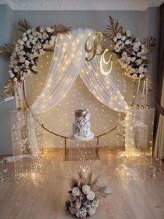 a wedding cake is surrounded by flowers and lights