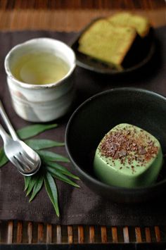 two desserts in small black bowls on a table