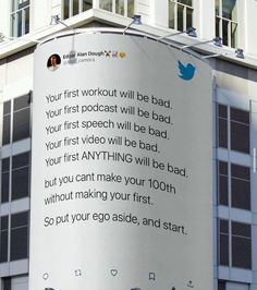 a large white sign on the side of a building that says, your first workout will be bad