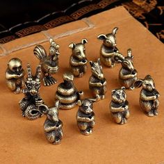 a bunch of small metal animals sitting on top of a piece of paper