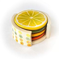 a stack of colorful plates with a slice of lemon on top of each plate in the middle