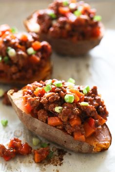 three stuffed sweet potatoes topped with ground beef